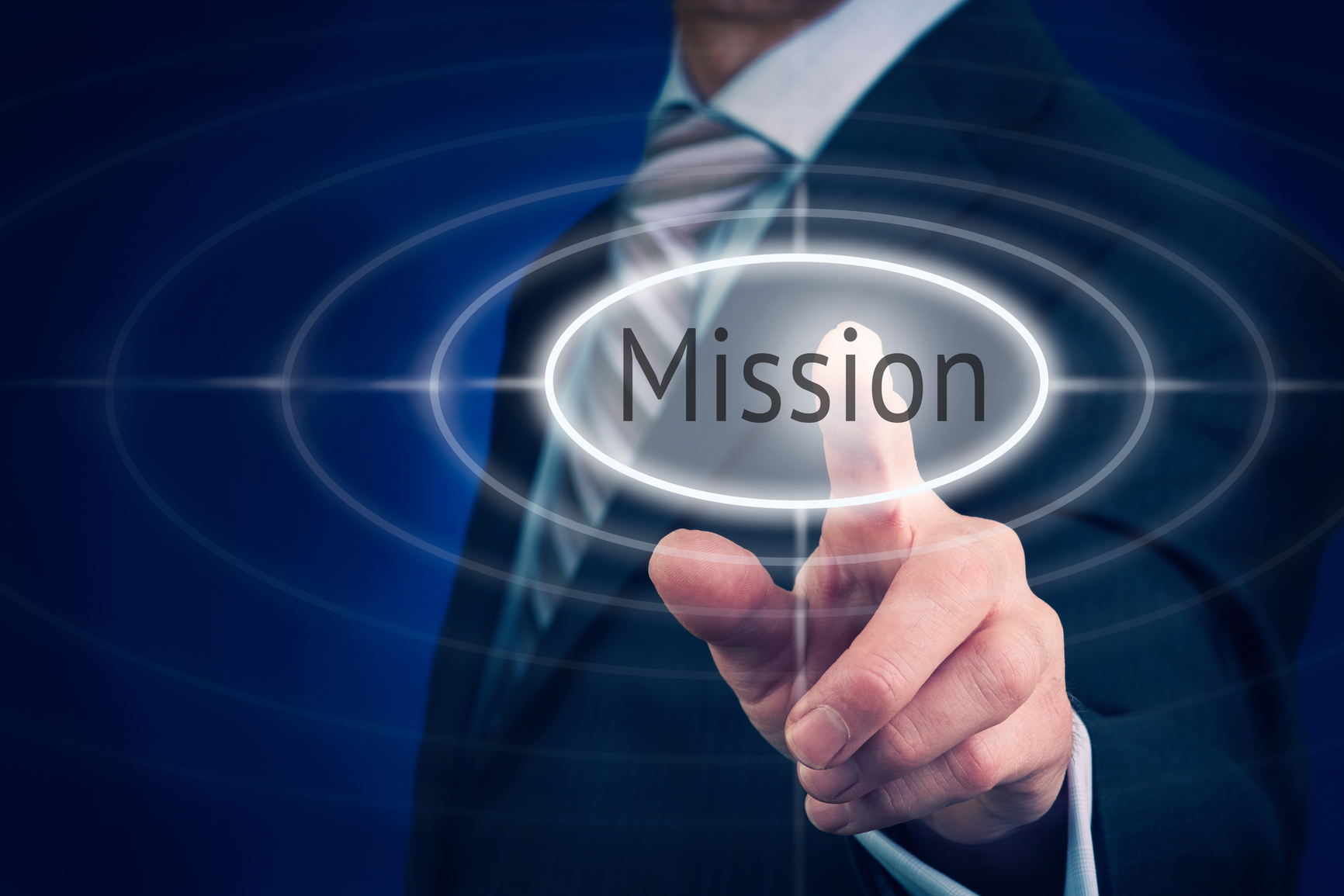 Businessman pressing a Mission concept button.